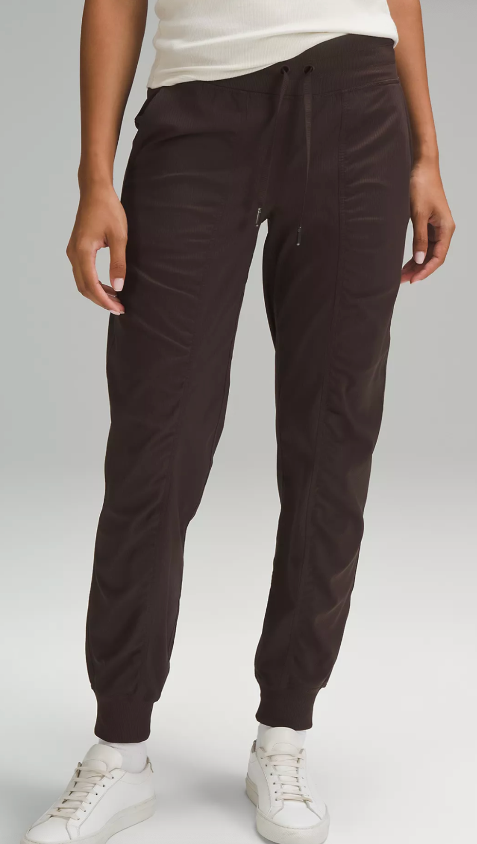 A Lululemon model wearing the Dance Studio Mid-Rise Jogger in Espresso.