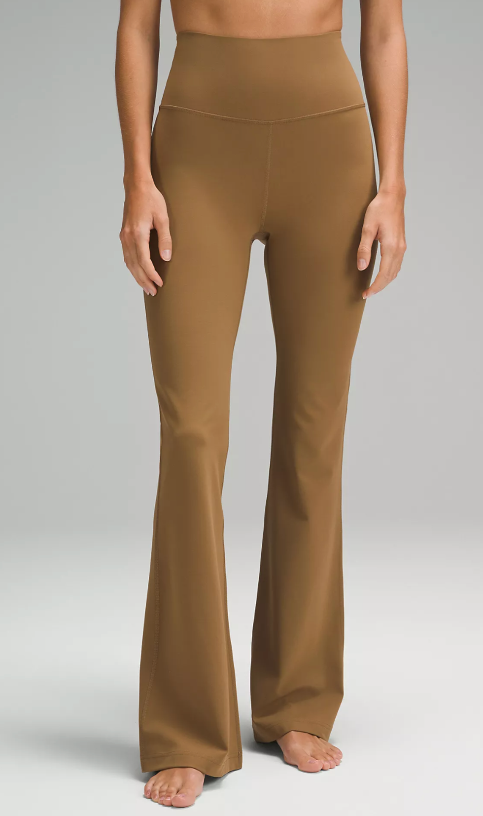 A Lululemon model wearing the Groove Super-High-Rise Flared Pant in Allspice.