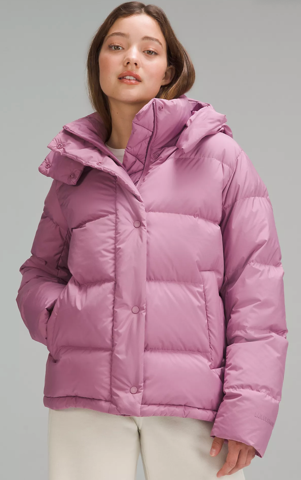 A Lululemon model wearing the Wunder Puff Jacket in Velvet Dust.
