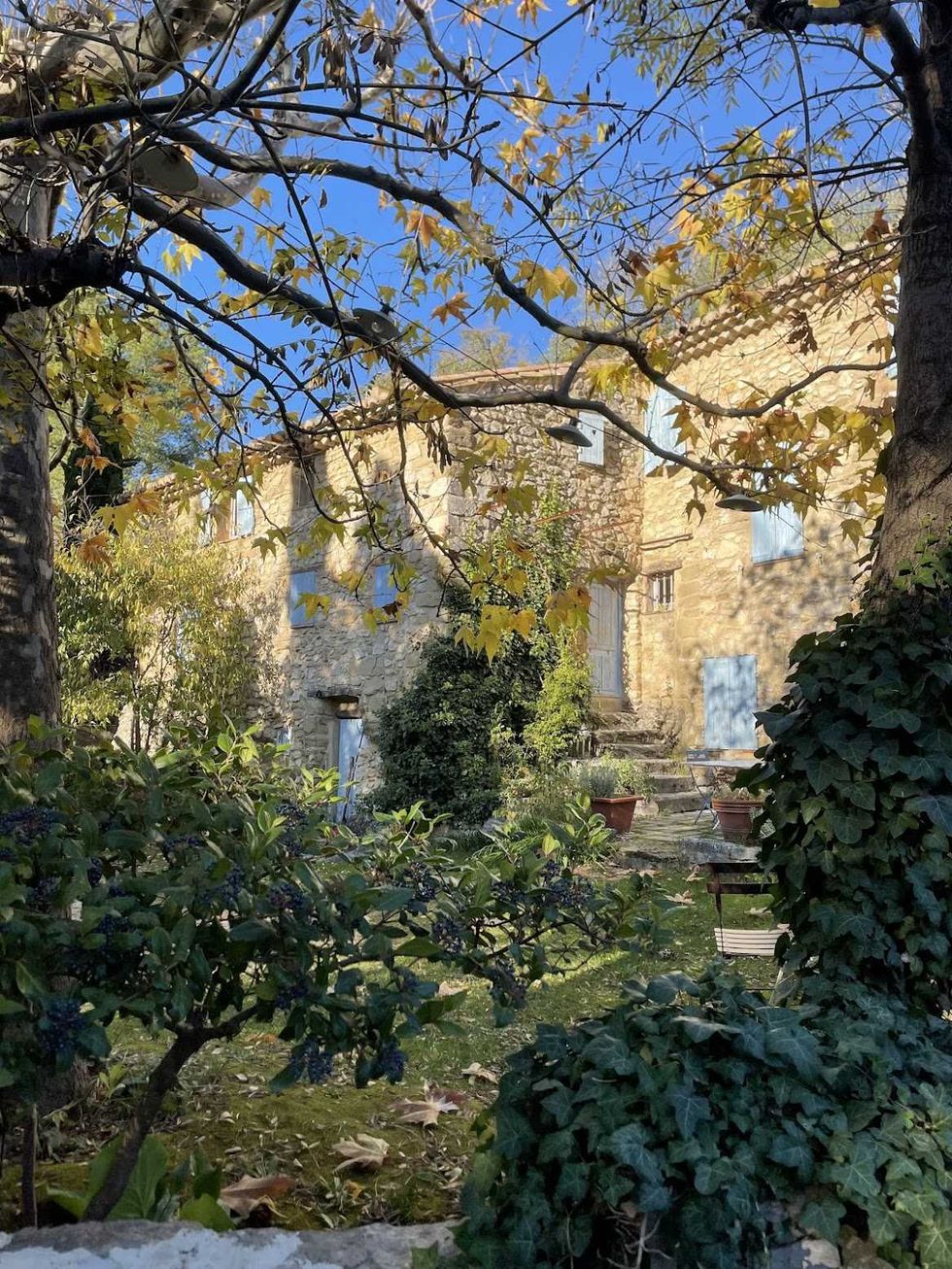 A lush garden in front of an old European house.