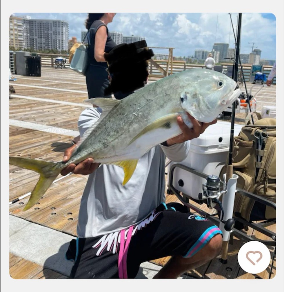 A man holding a fish.