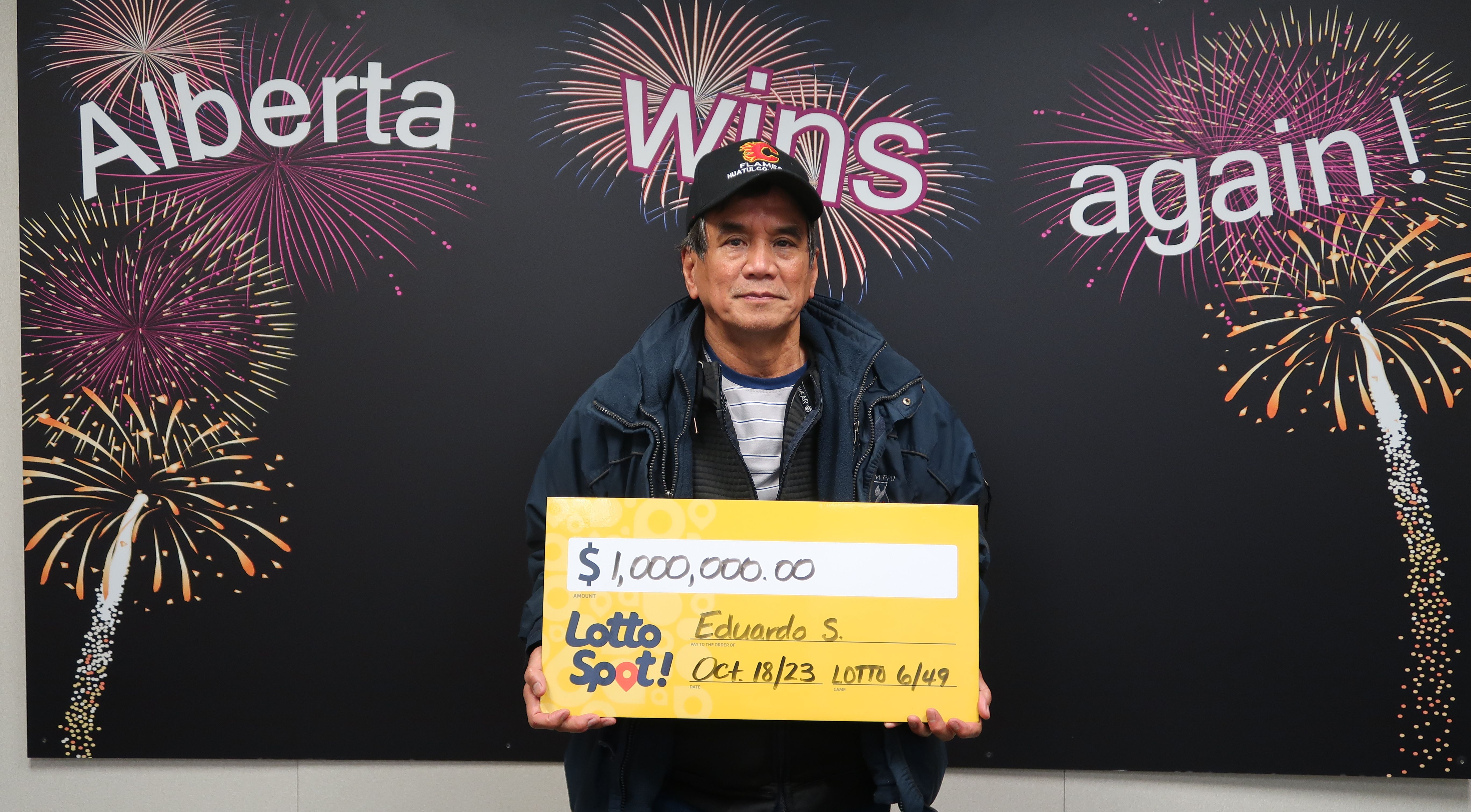 A man holding his lottery wins.