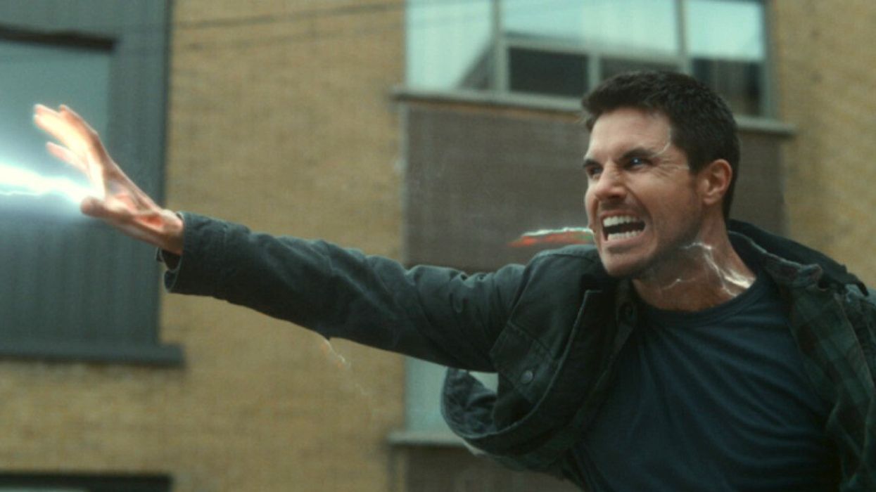 A man looking angry with an electric current coming out of his hand.