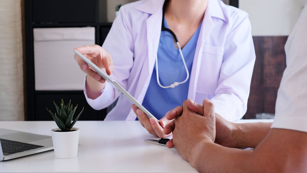 A man meeting with a doctor.