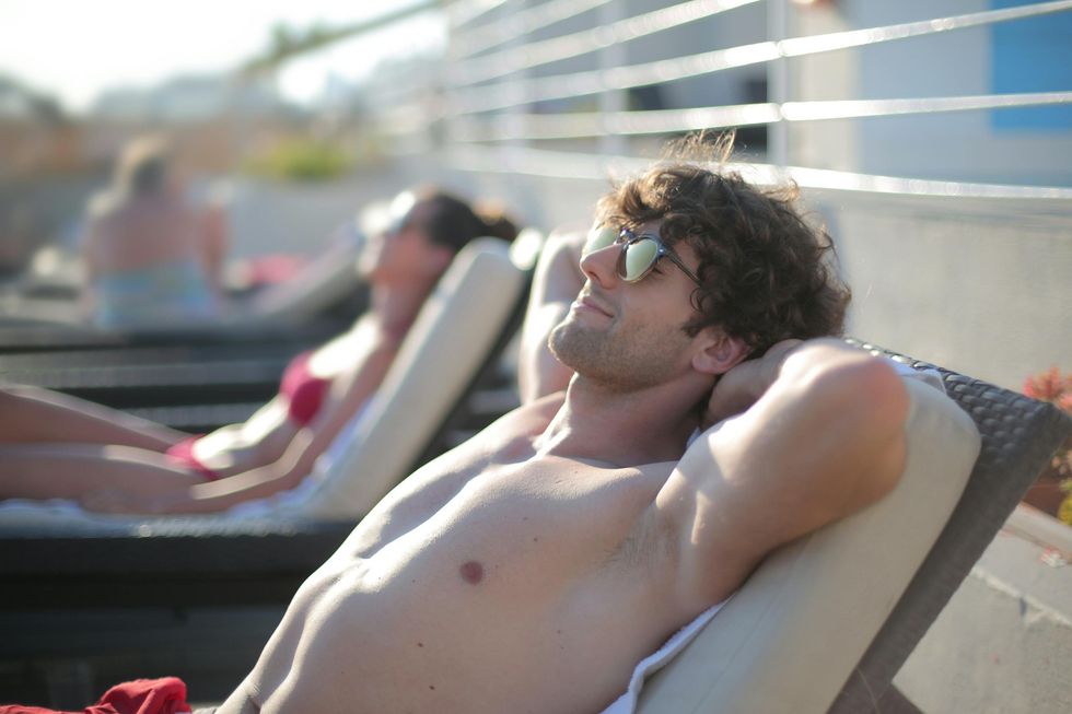 A man relaxing on a sun lounger.