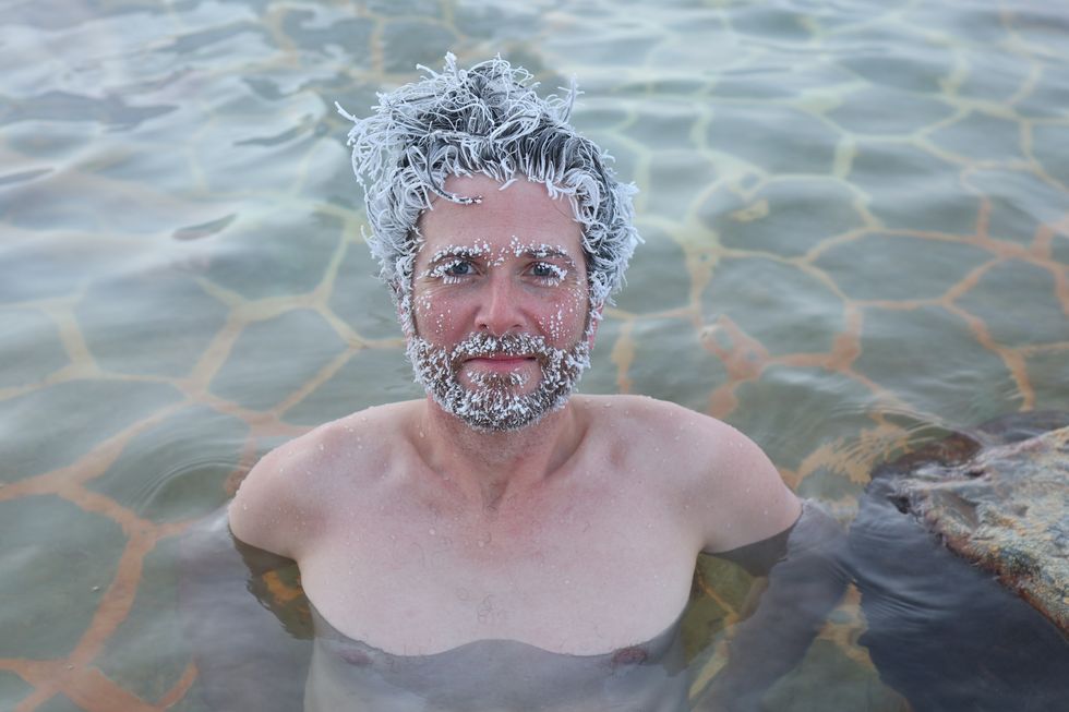 A man showcases frosted hair, eyebrows and facial hair.