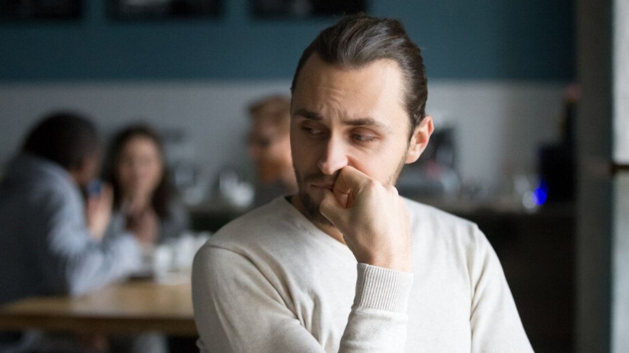 A man sitting alone at a cafe.