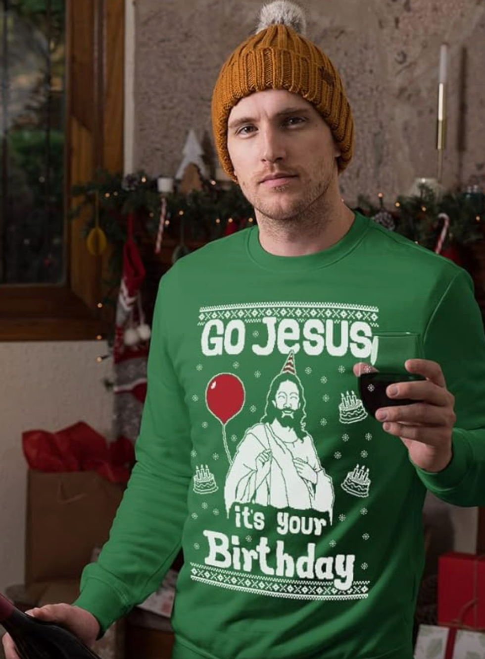A man wearing a green Christmas sweater that says "Go Jesus, it's your birthday" on it.
