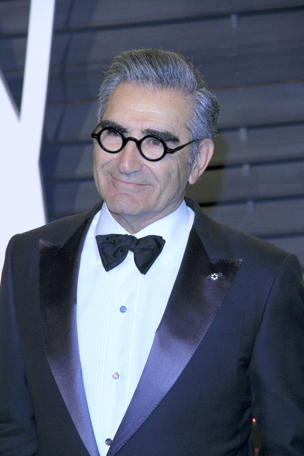 A man wearing glasses and a tux at an awards show.