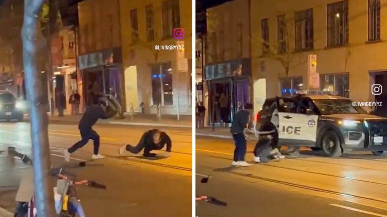 A man with a snake using it as a weapon in downtown Toronto.