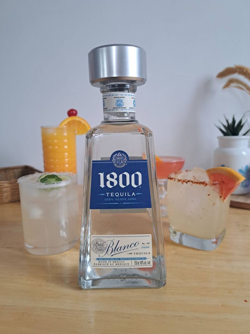 A margarita, tequila sunrise, siesta and paloma arranged around a bottle of 1800 Blanco.
