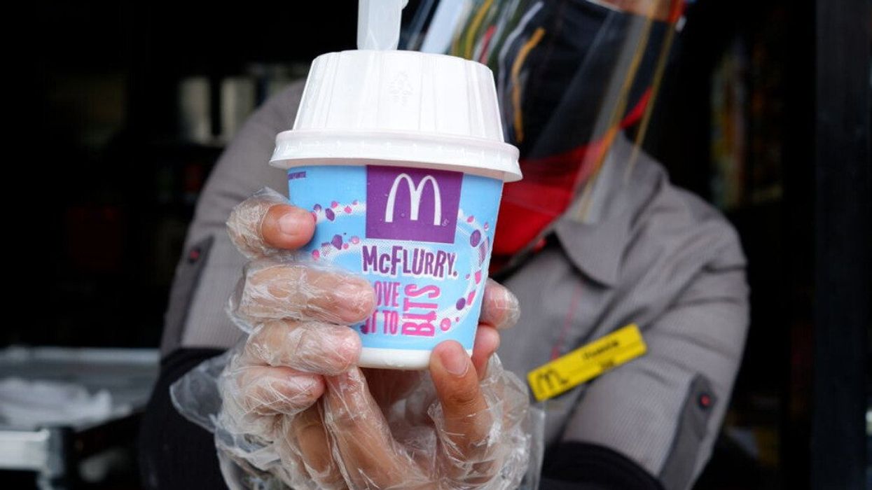 A McDonald's worker holding a McFlurry.