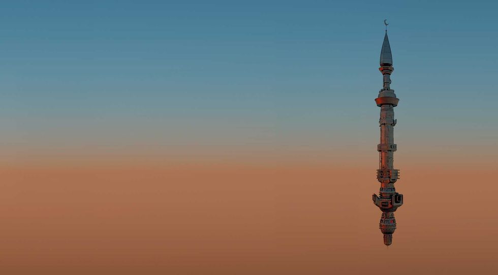 A minaret floats in the evening dusky sky.