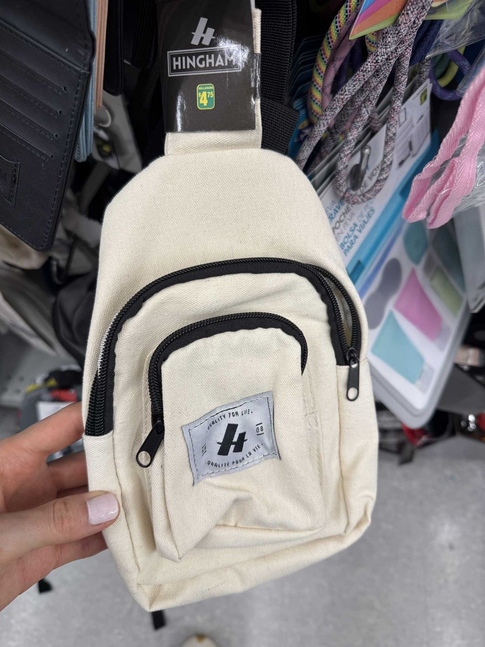 A mini beige and black crossbody bag.
