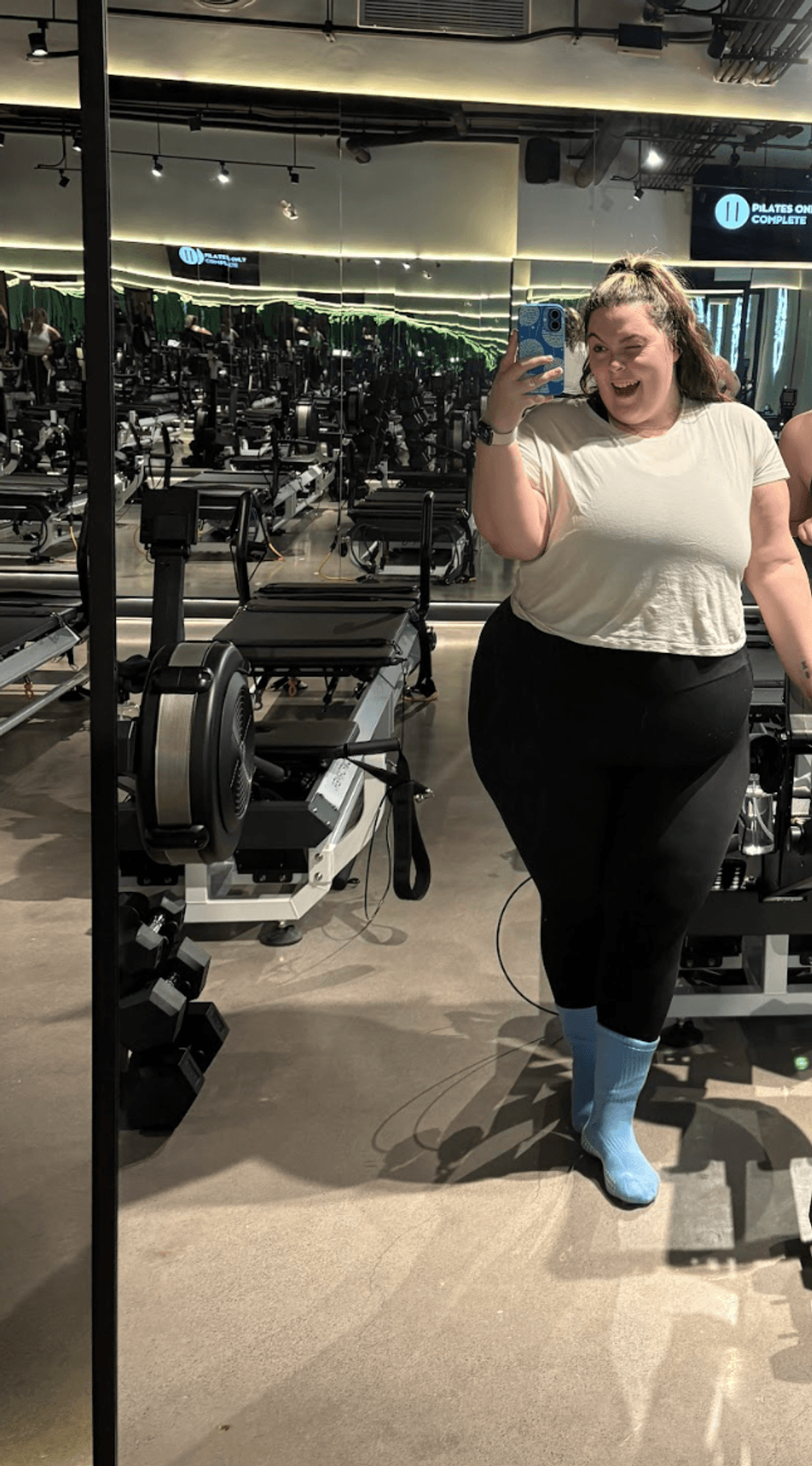 A mirror selfie at a workout studio.