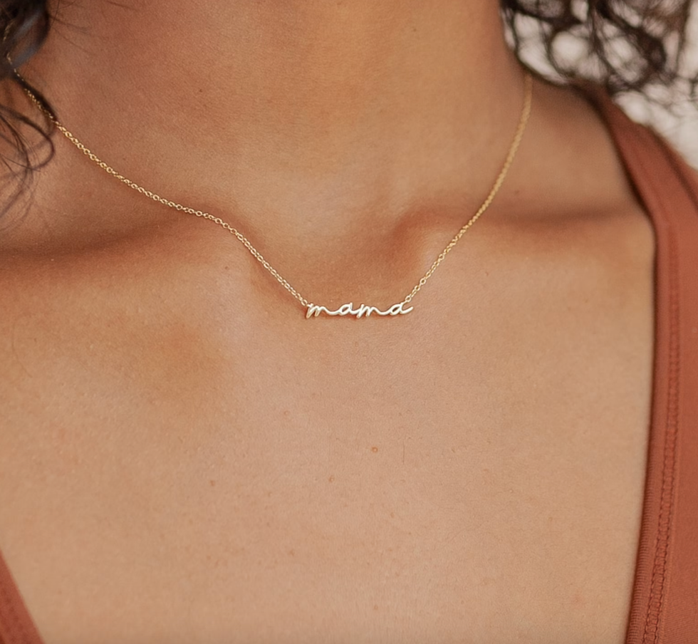 A model wearing a "mama" necklace.