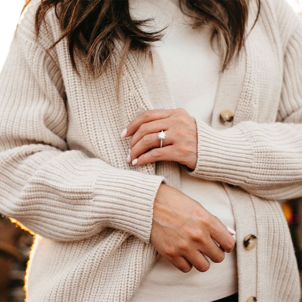 A model wearing a round engagement ring.