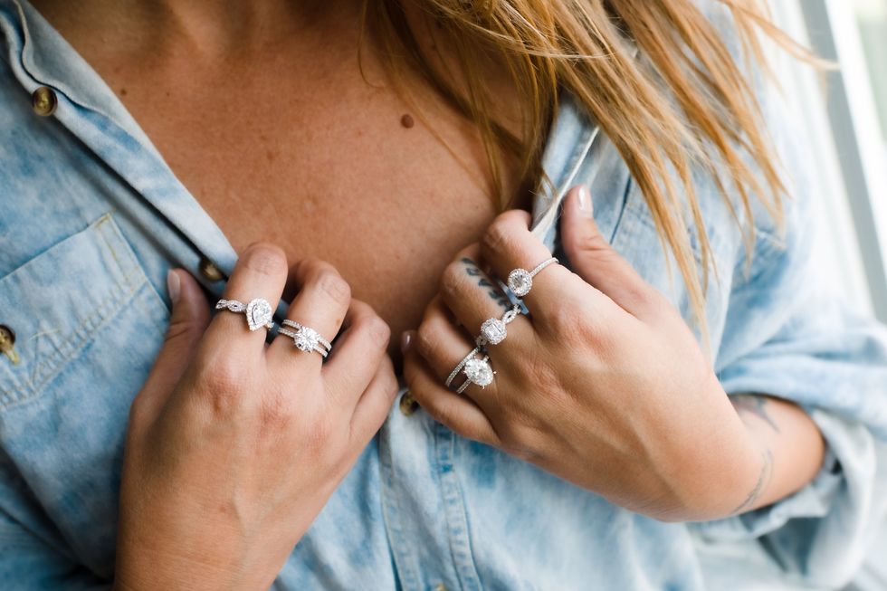 A model wearing a variety of lab-created diamond engagement rings.
