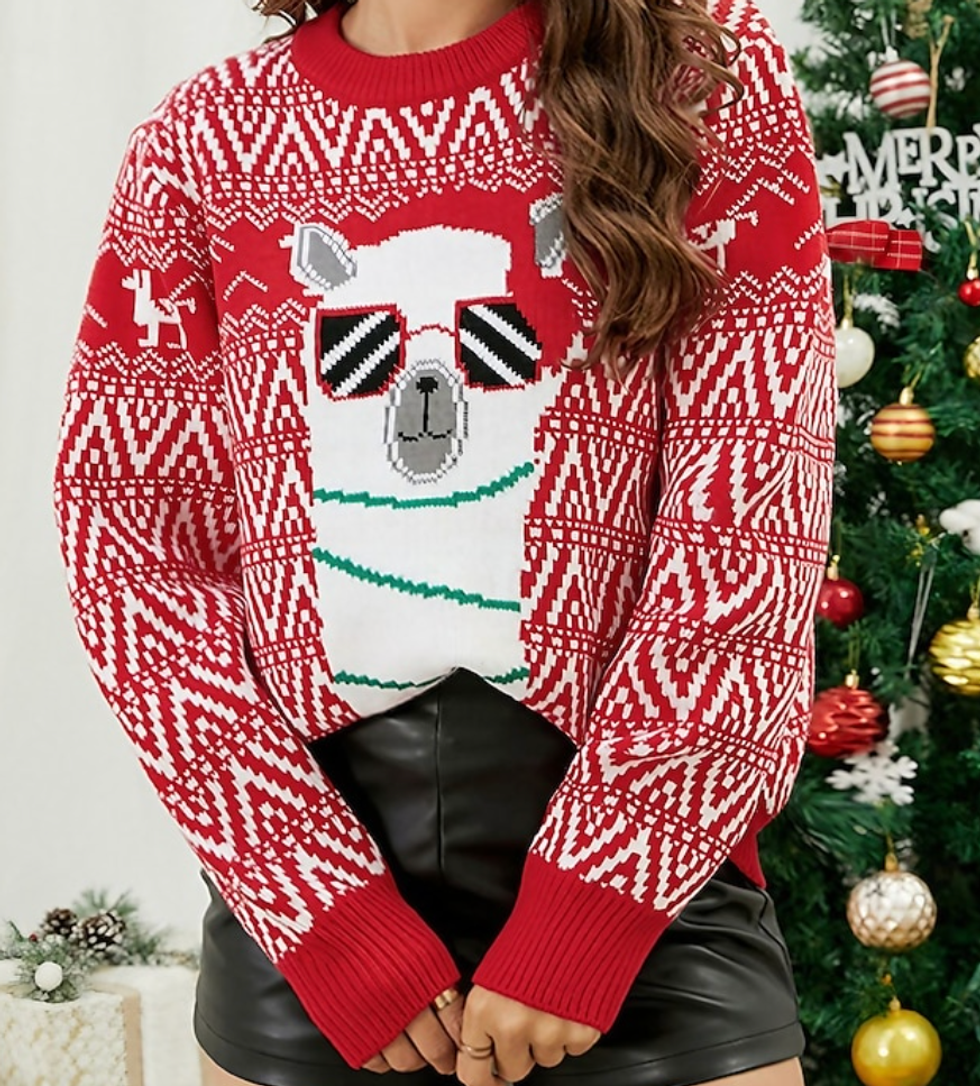 A model wearing a white and red Christmas sweater with a llama wearing sunglasses.
