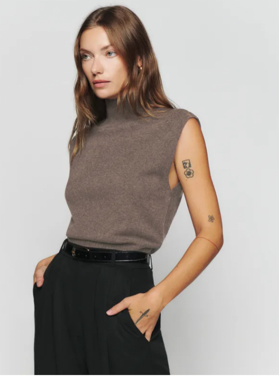 A model wearing the Arco Cashmere Sleeveless Turtleneck Sweater.