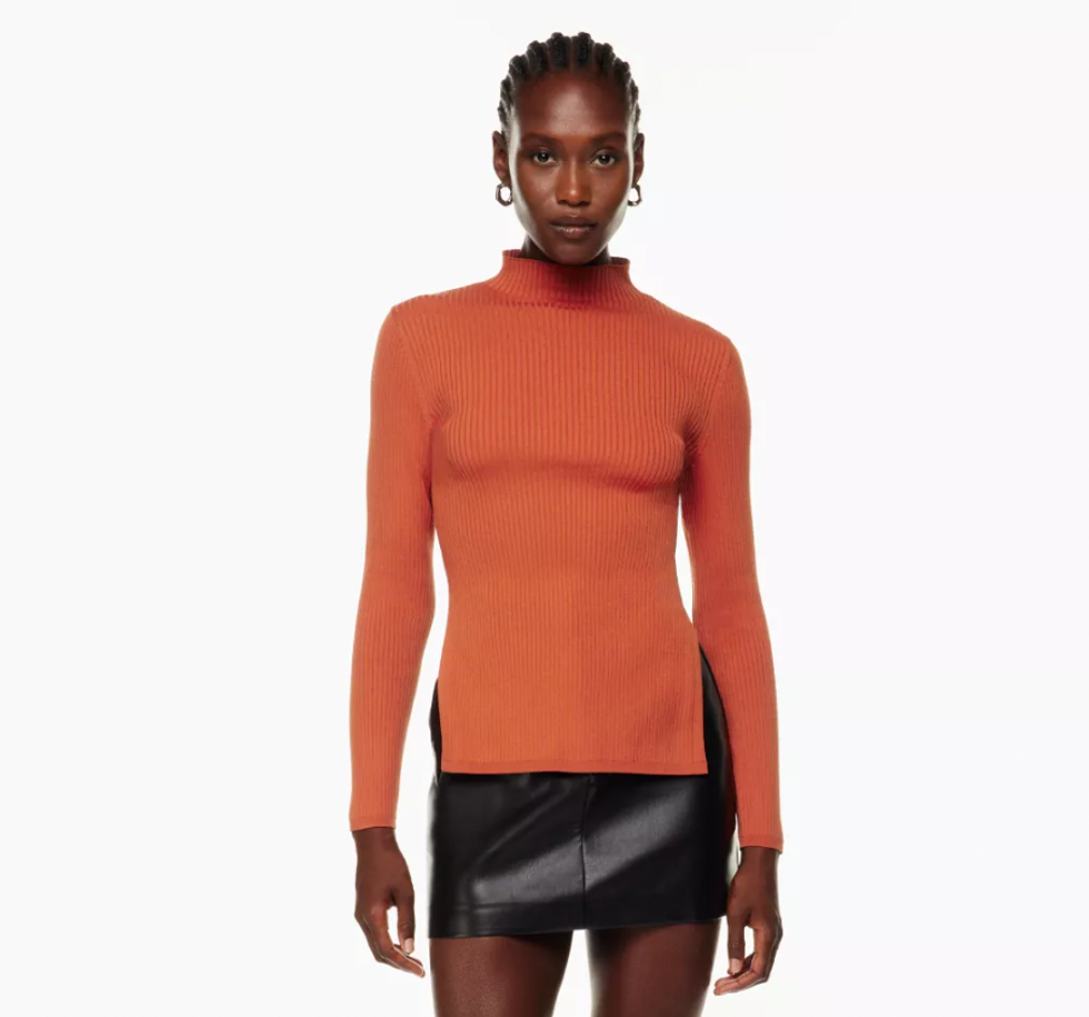 A model wearing the Sculpt Knit Tie-Back Longsleeve from Aritzia.