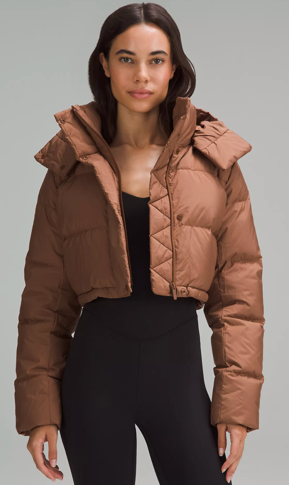 A model wearing the Wunder Puff Super-Cropped Jacket in the colour Roasted Brown.