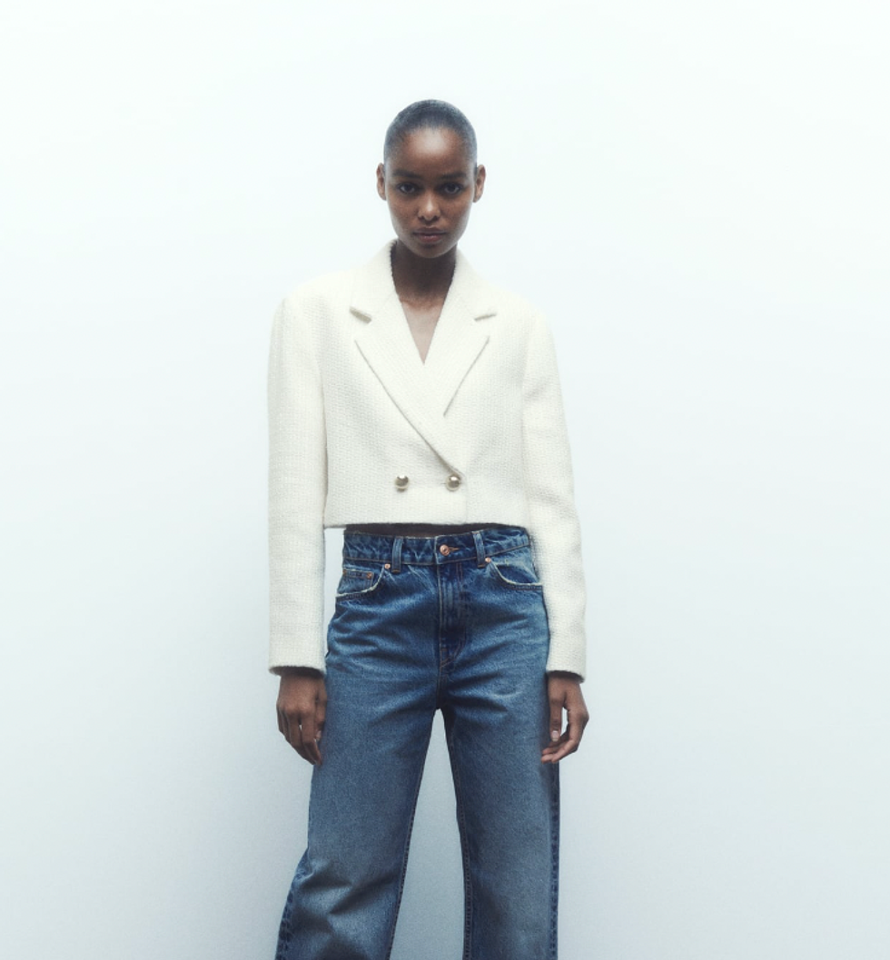 A model wearing Zara's Textured Short Blazer.