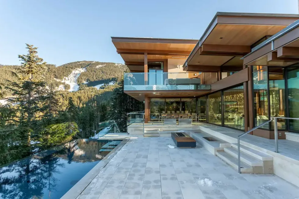 A modern property with an infinity pool overlooking the mountains.
