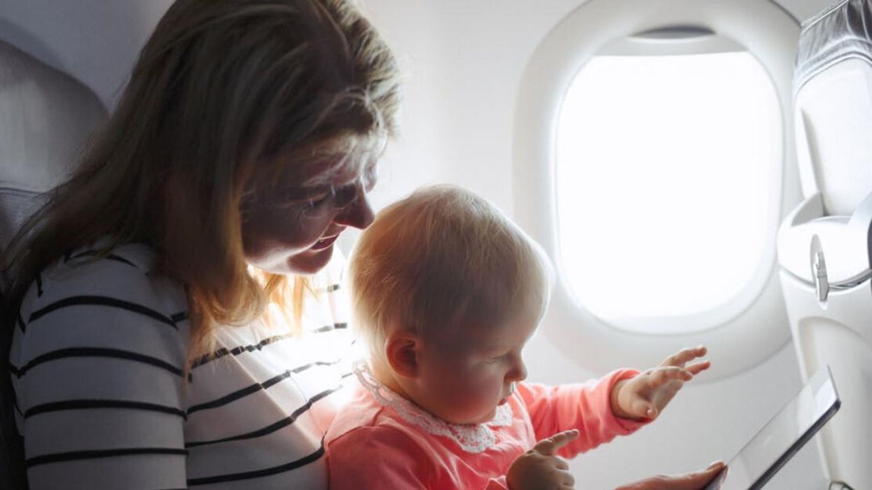A mom and baby on a plane.