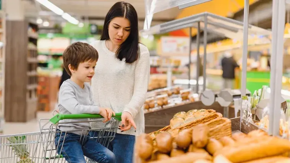 A mom and child at a grocery store.