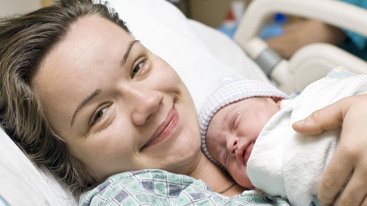 A mom with her newborn child at the hospital.