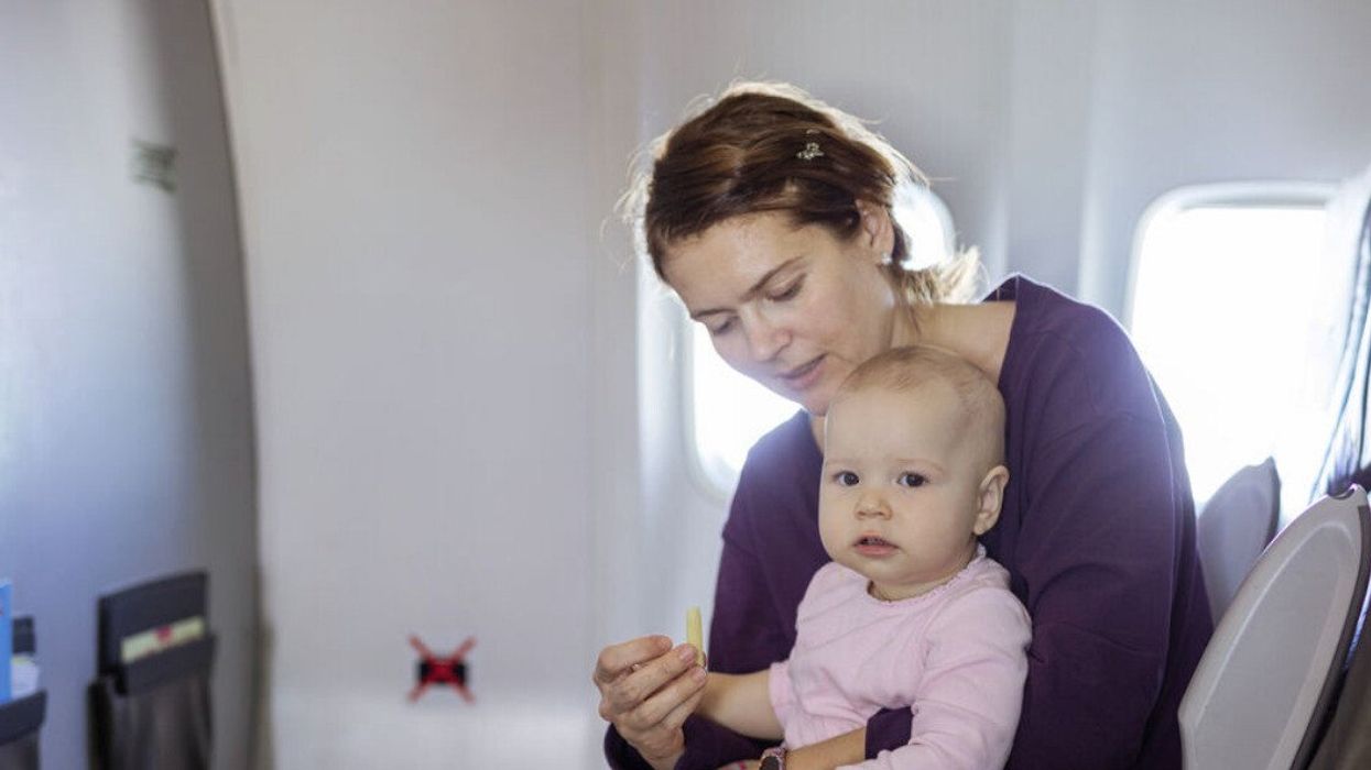 A mother and her baby on a plane.