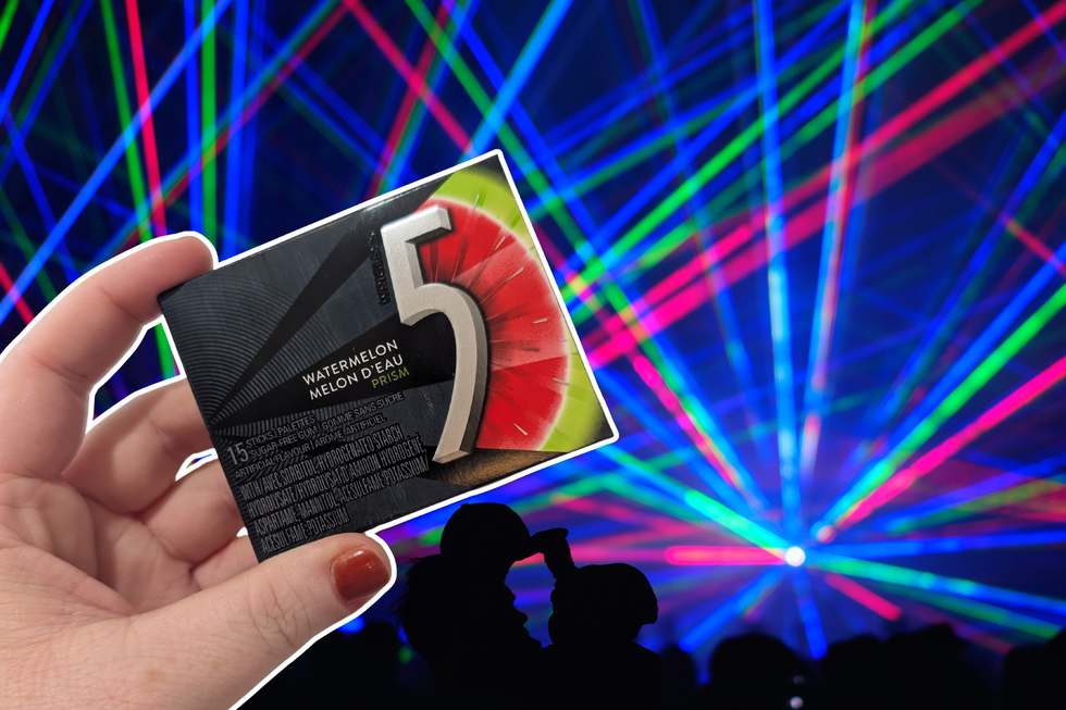 A neon light show at a rave. A hand holding Prism flavour 5 Gum is on top.