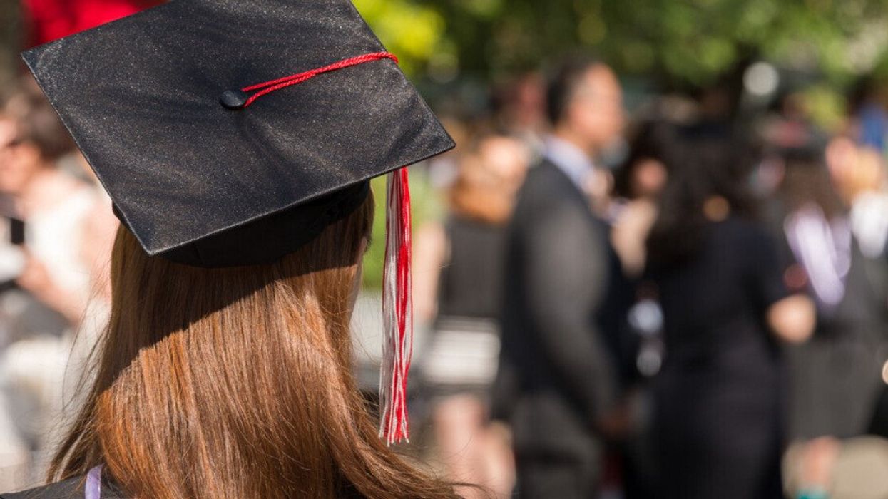 A new graduate at their graduation ceremony.