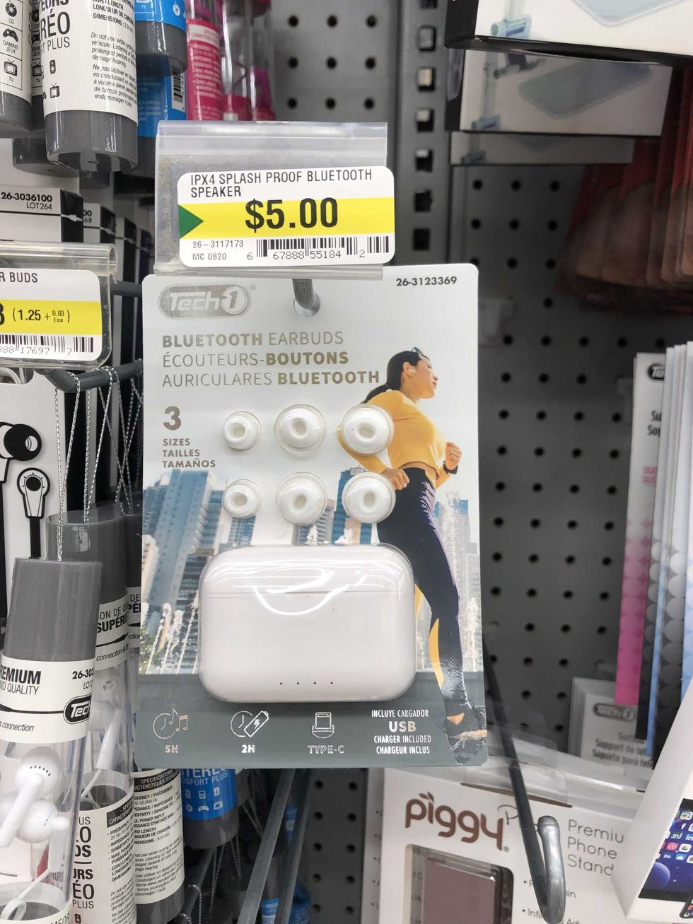 A pack of white earbuds hanging on a store shelf.