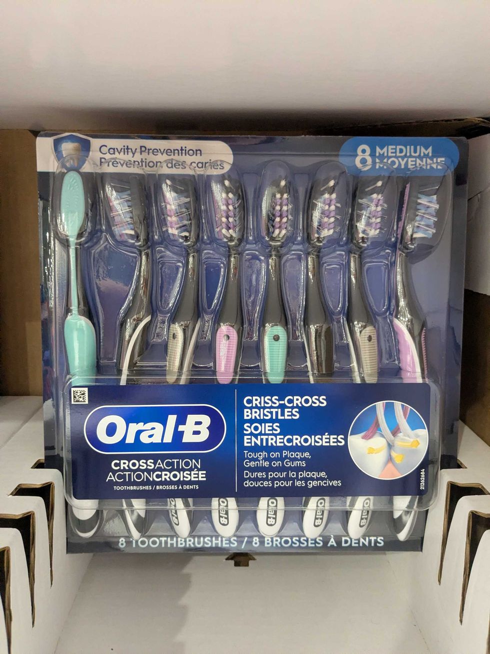 A package of 8 toothbrushes on a shelf