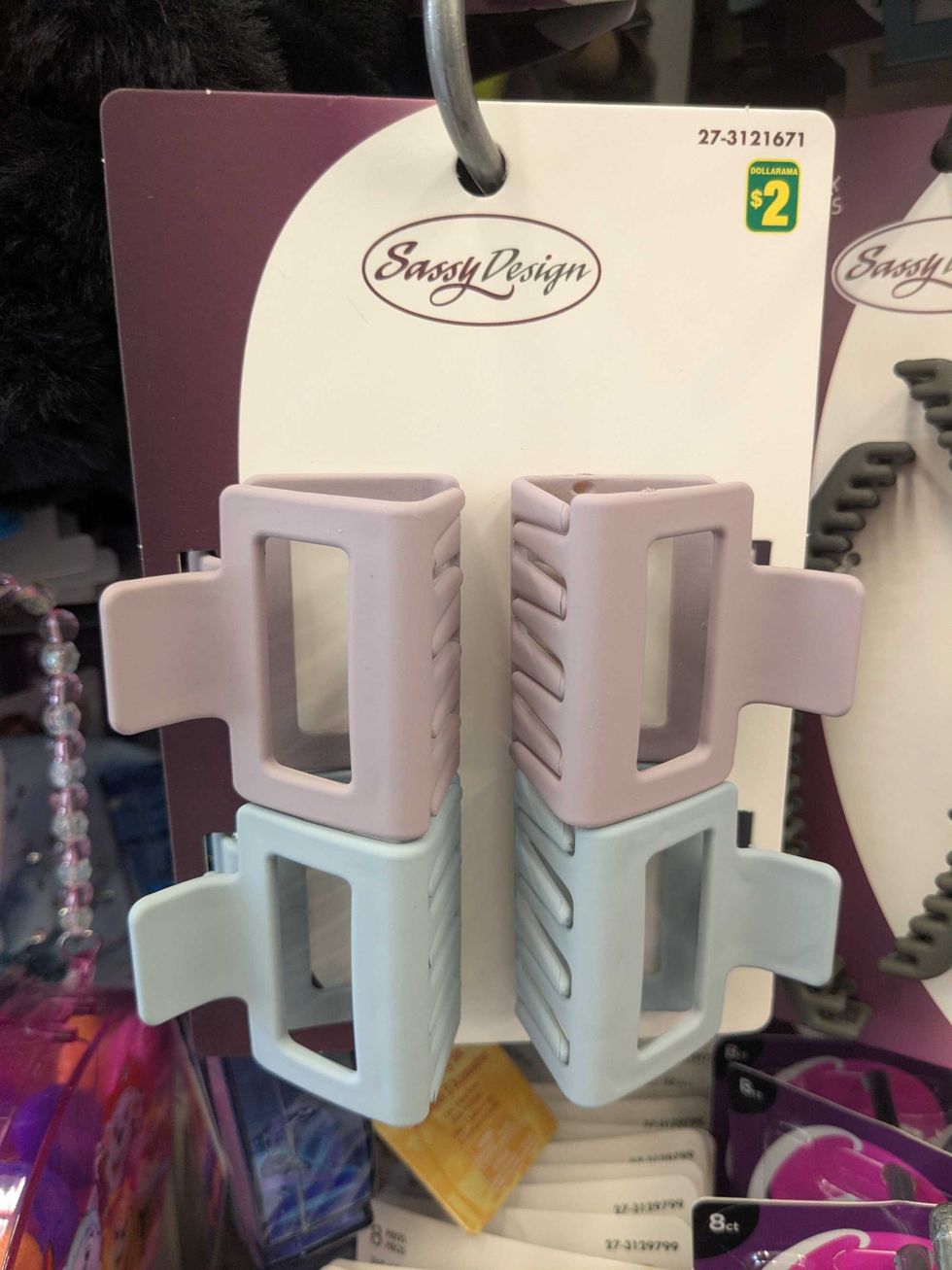A package of four hair clips hanging on a shelf at Dollarama
