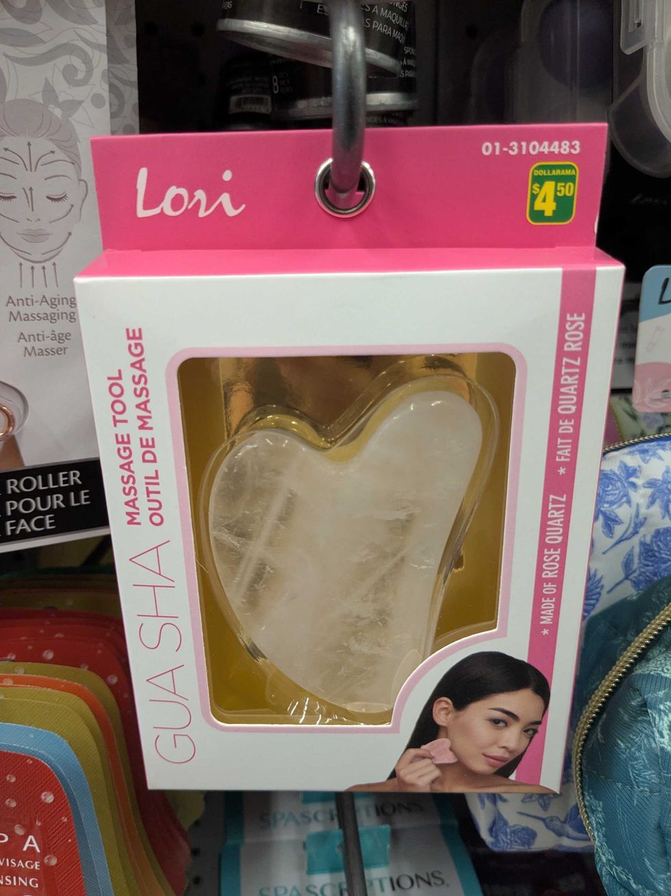 A package with a gua sha massage tool on the shelf