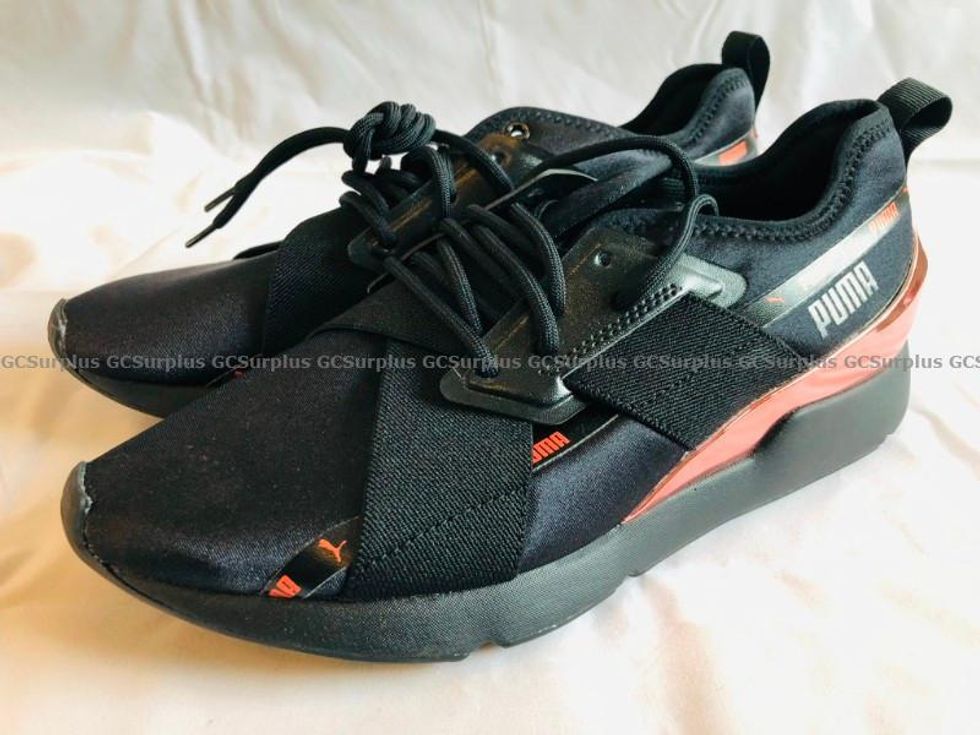 A pair of black and orange 9.5 Puma Muse X-2