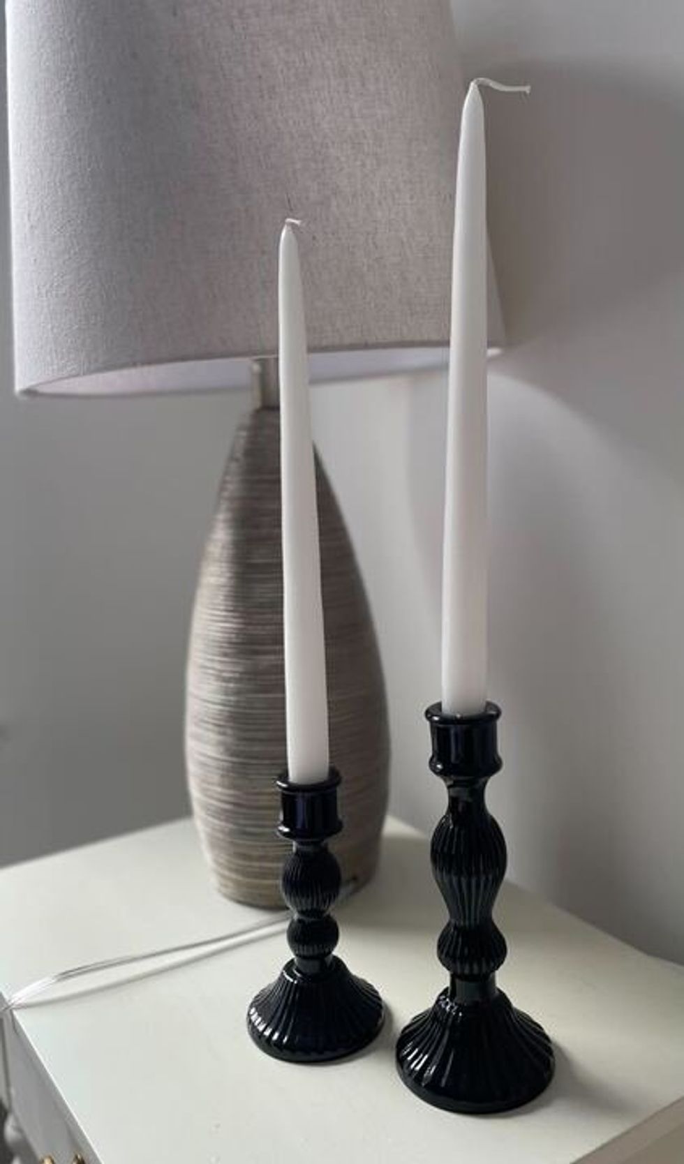 A pair of black candle stick holders.