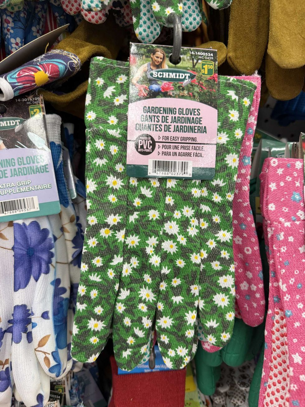 A pair of green gardening gloves with white and yellow flowers on them.