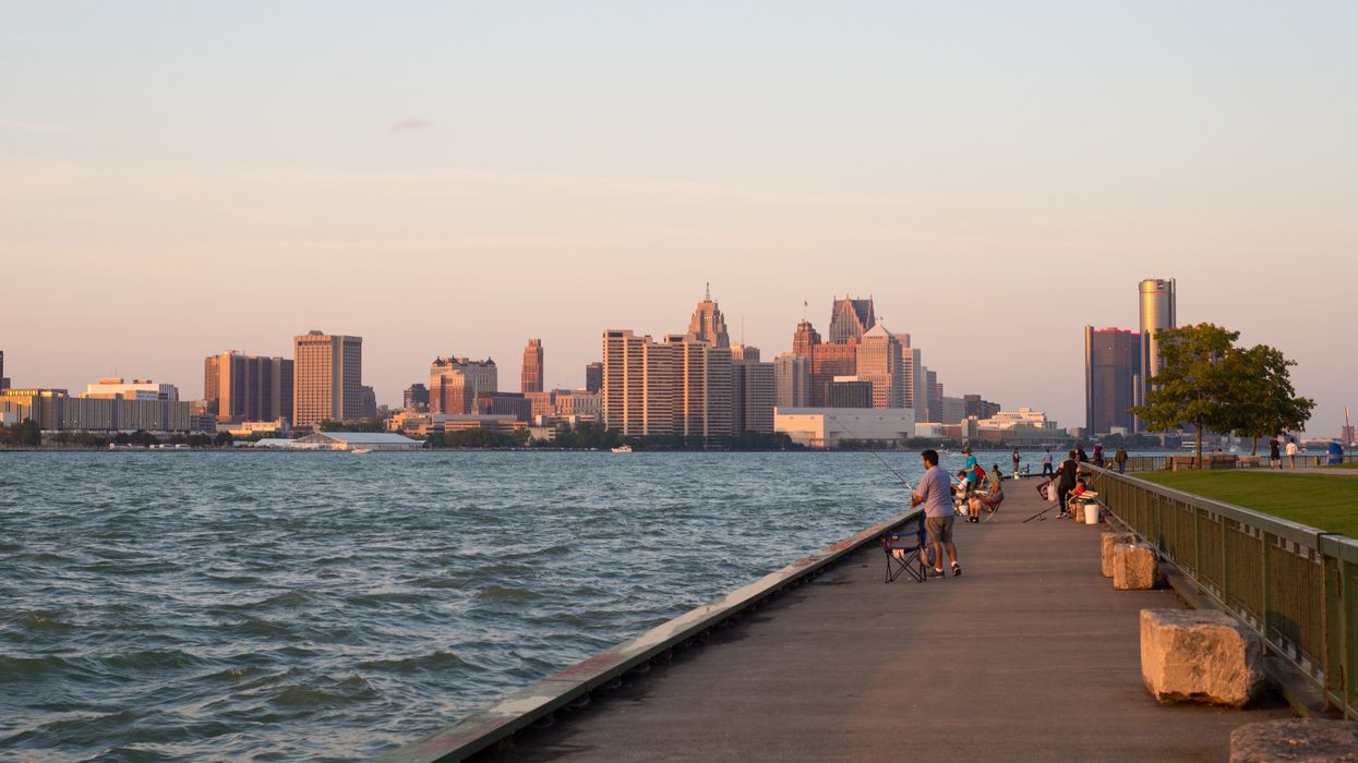 A panoramic view of Windsor's waterfront with downtown Detroit skyline and the General Motors Renaissance Center in the background.