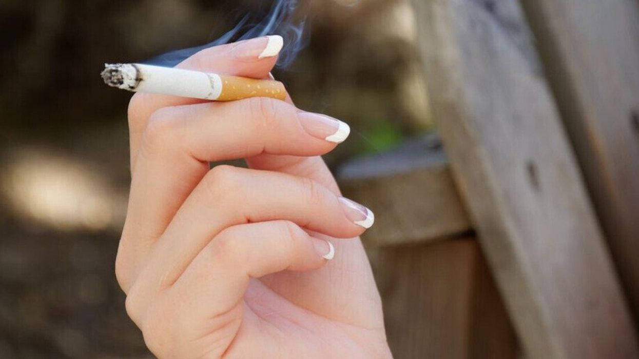 A person holding a cigarette.