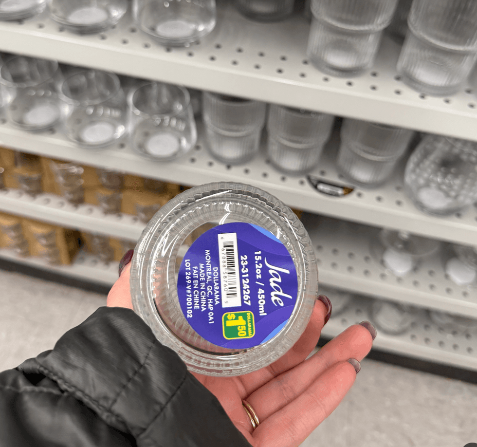 A person holding a glass, showing the bottom.