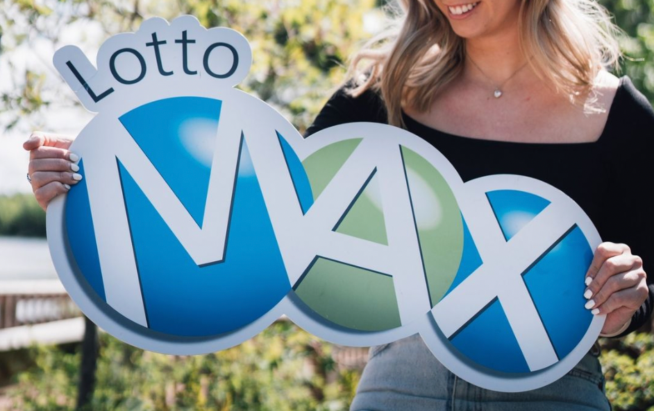 A person holding a Lotto Max sign.