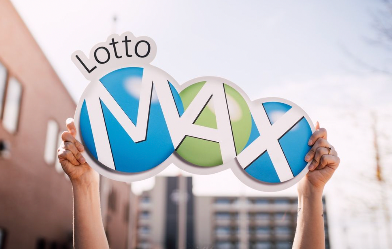 A person holding up a Lotto Max sign.