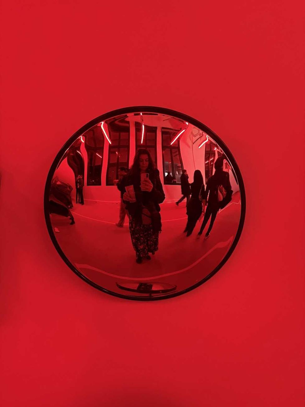 A person in a round mirror.