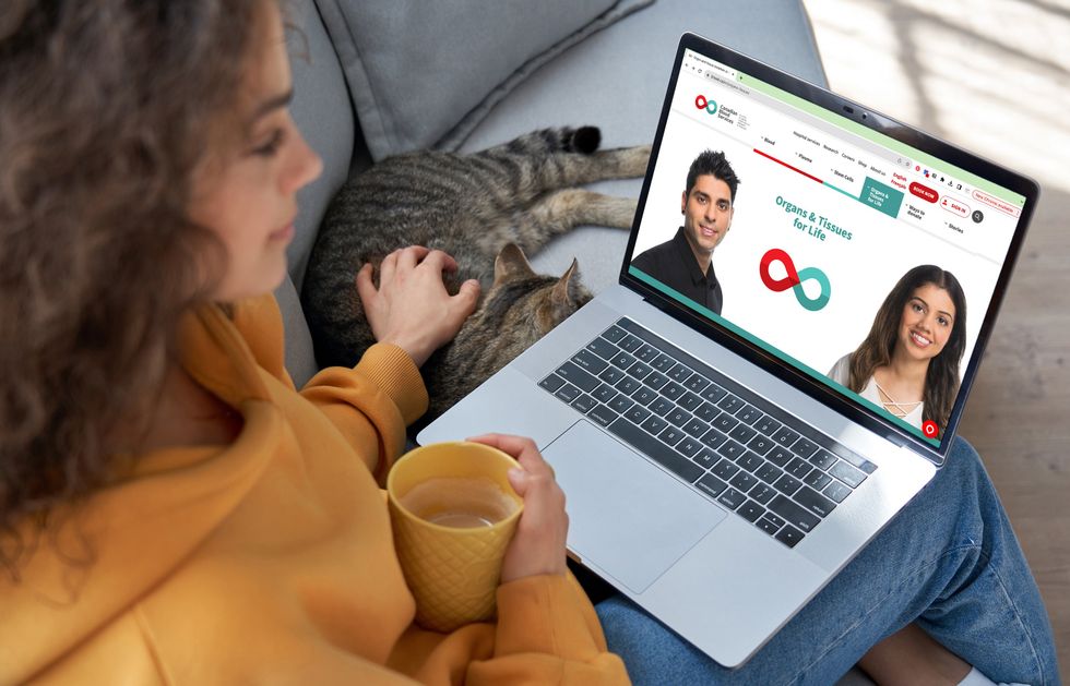 A person looking at the Canadian Blood Services website Organ and Tissues information page while sitting on a couch next to a cat.