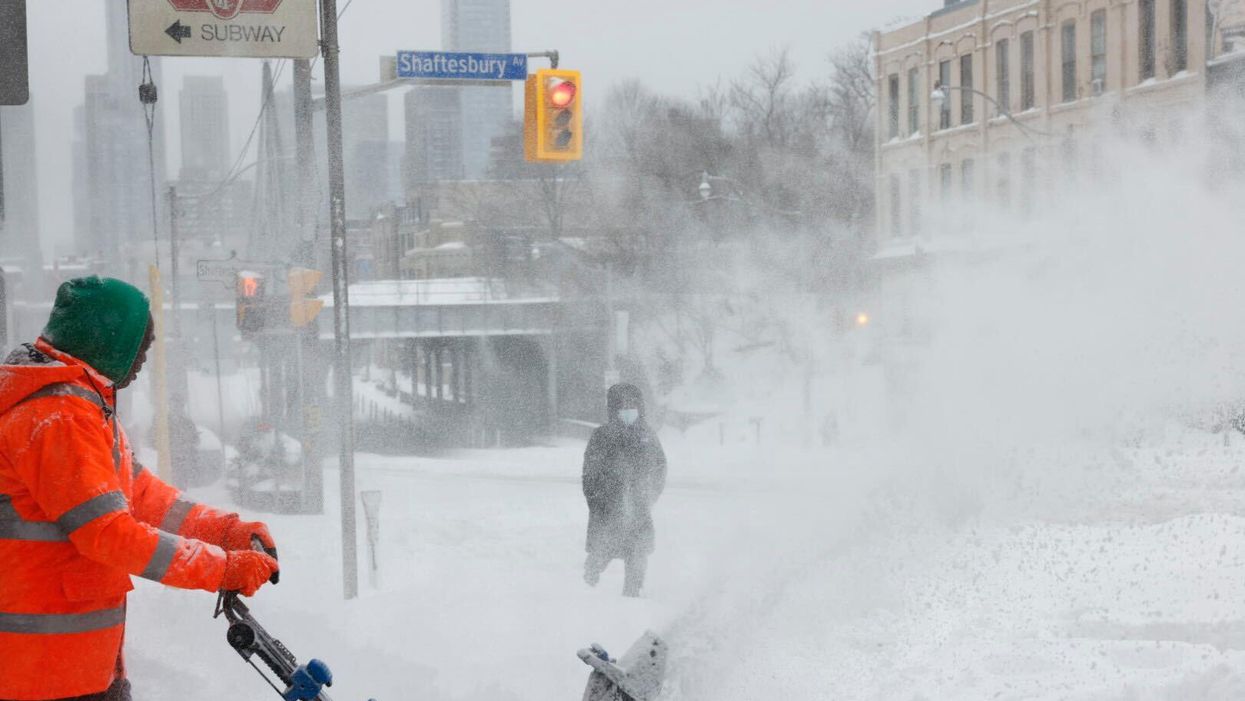 A person plowing snow with a tractor.