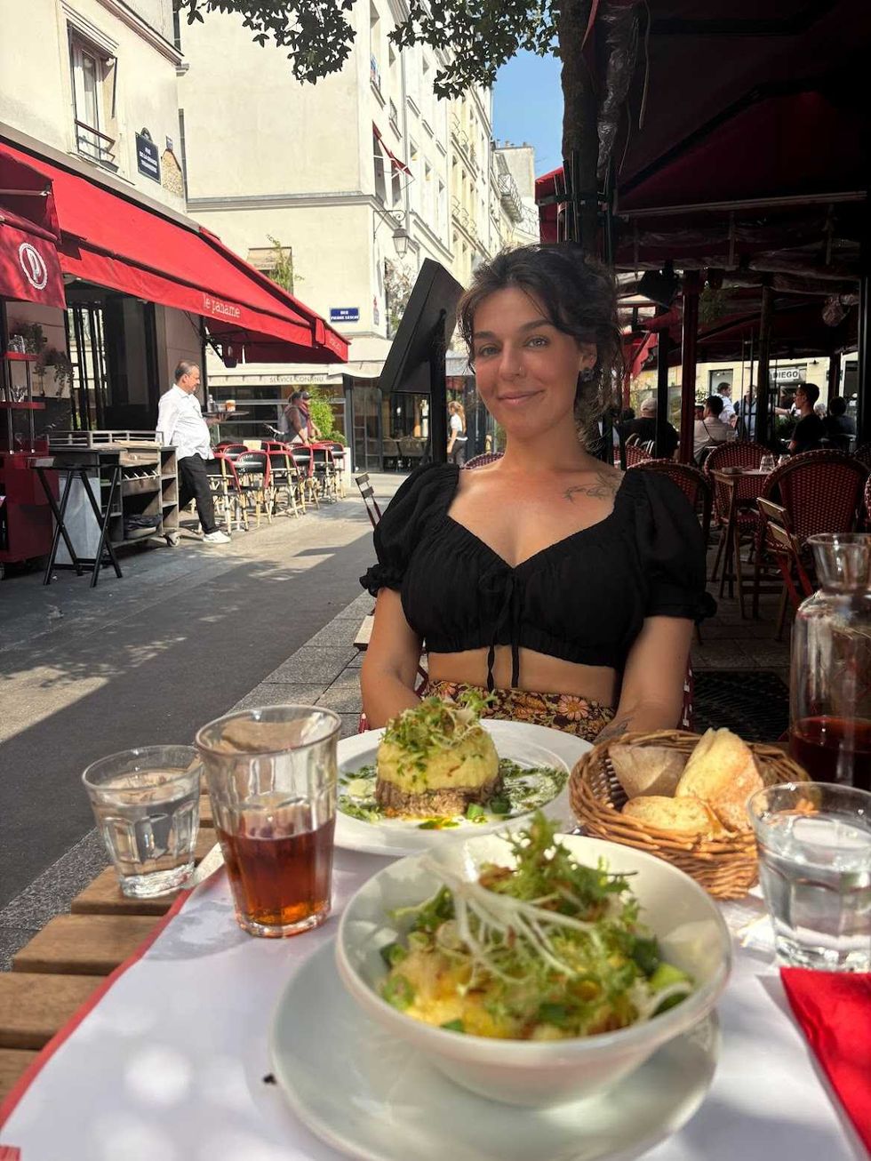 A person sitting in front of a table of food.